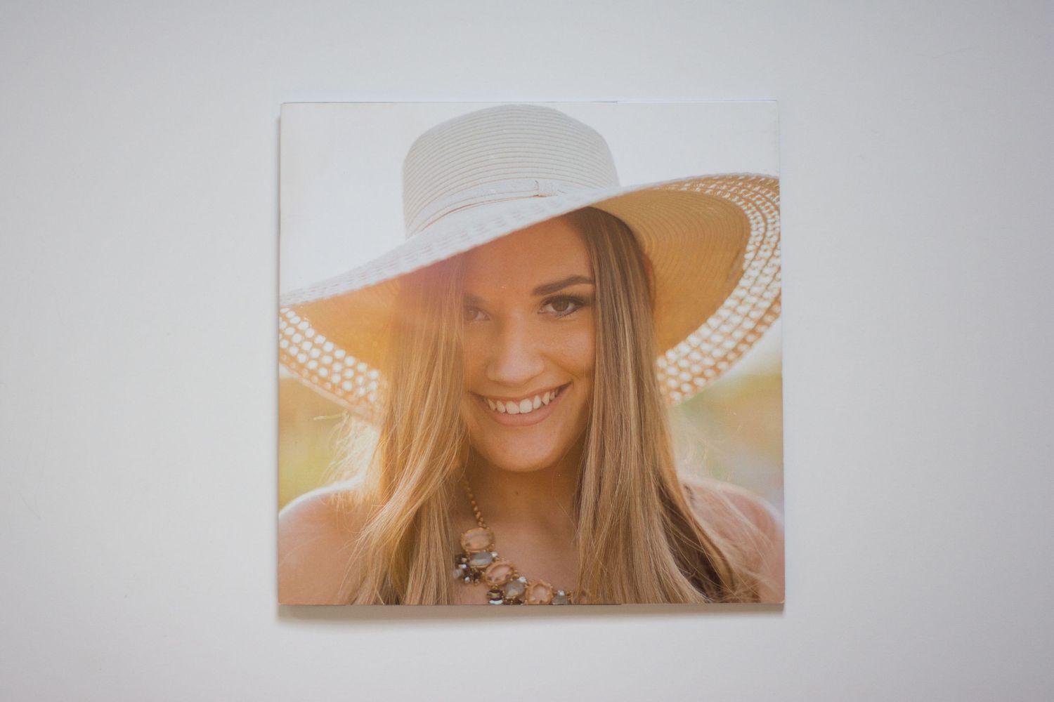 Artistic photo album spread showing portrait images with a warm golden sunlit aesthetic.