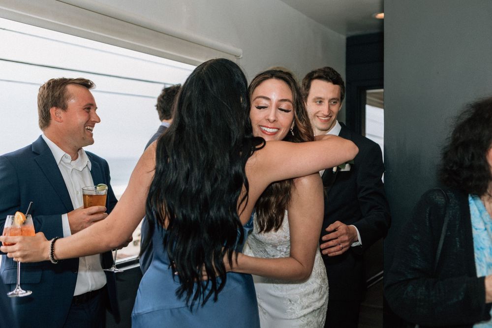 Malibu film photographer capturing guests mingling during a beachside dinner reception.