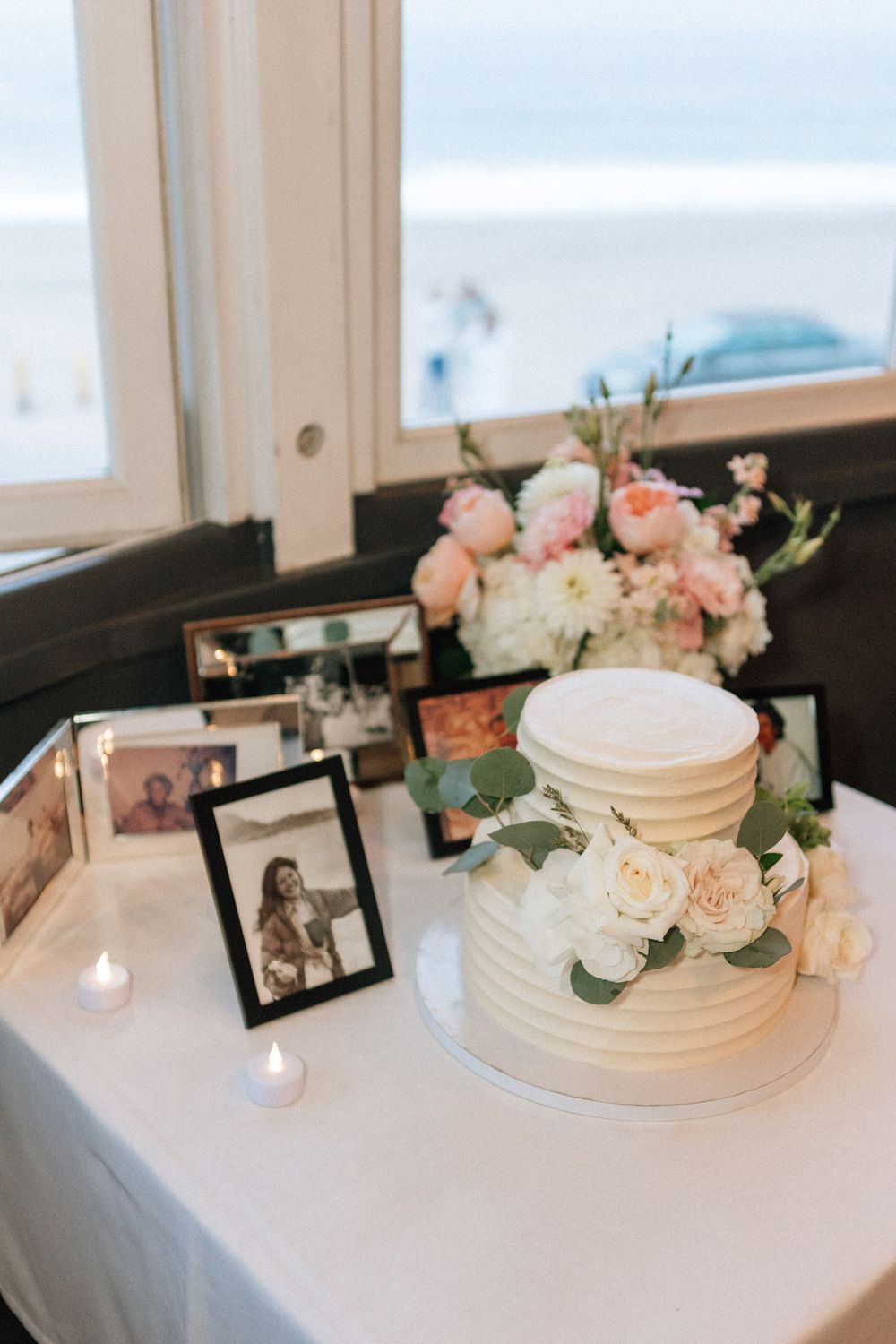 Malibu wedding reception details including a memorial table and classic wedding cake.