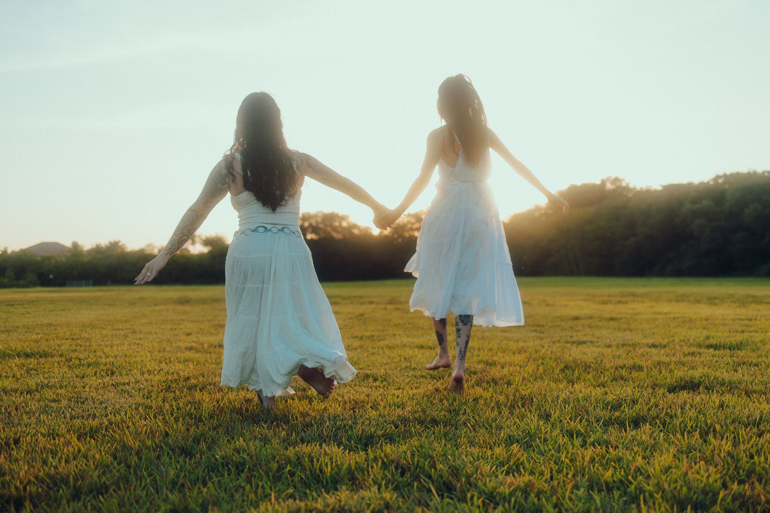 Cinematic South Florida editorial of two women walking into sunset, Interstellar tones. Perfect for FAU Theatre performers. MannyPortraits.