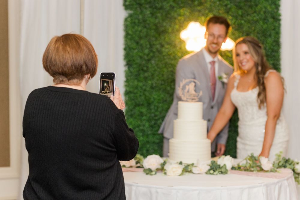 Wedding guests dancing and enjoying themselves on a white dance floor at an elegant reception venue.