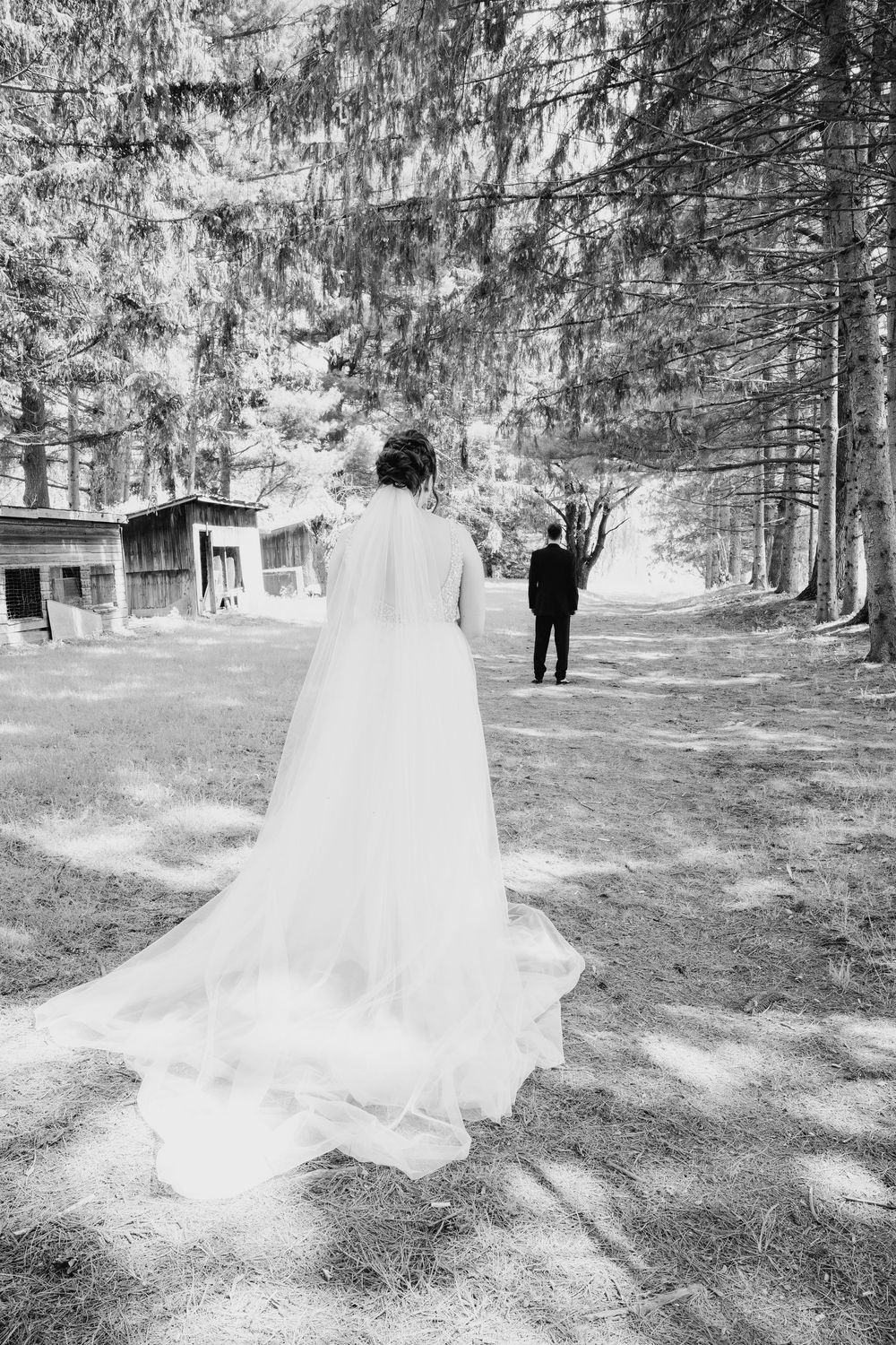 A ghostly white dress appears to float ethereally through a wooded outdoor setting in this artistic black and white series.