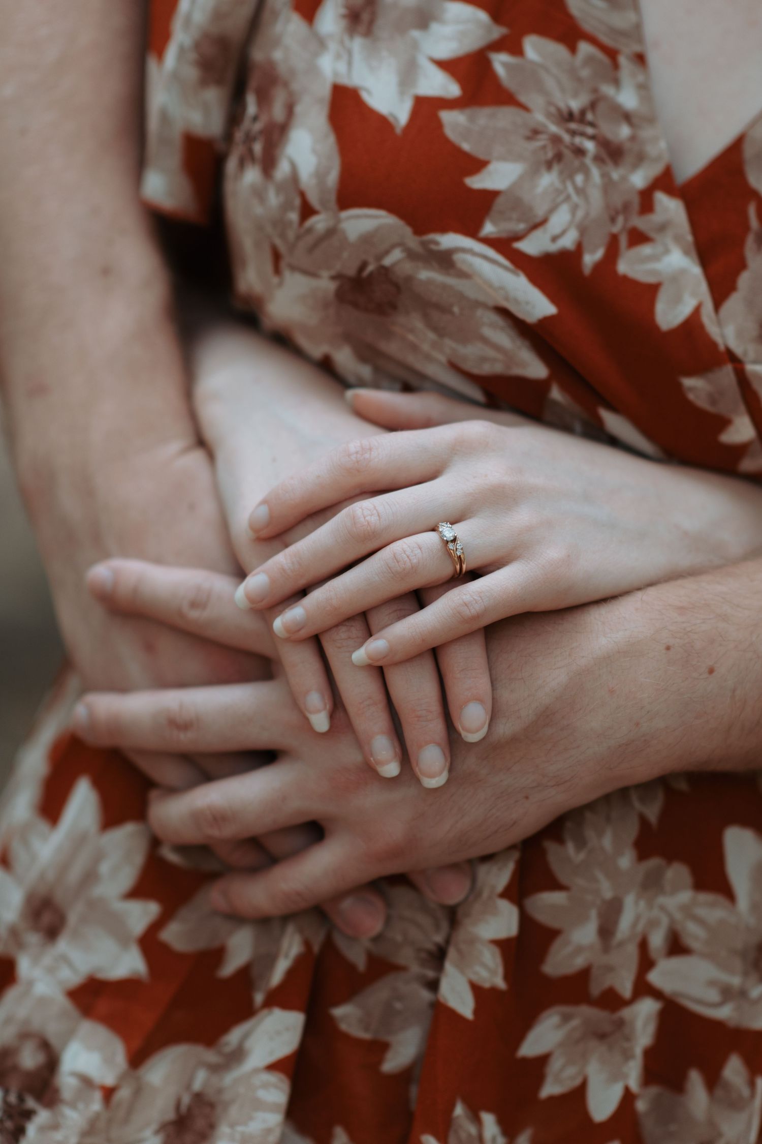 Two young lovers hands tangled up during an engagement session in Post Falls, Idaho.