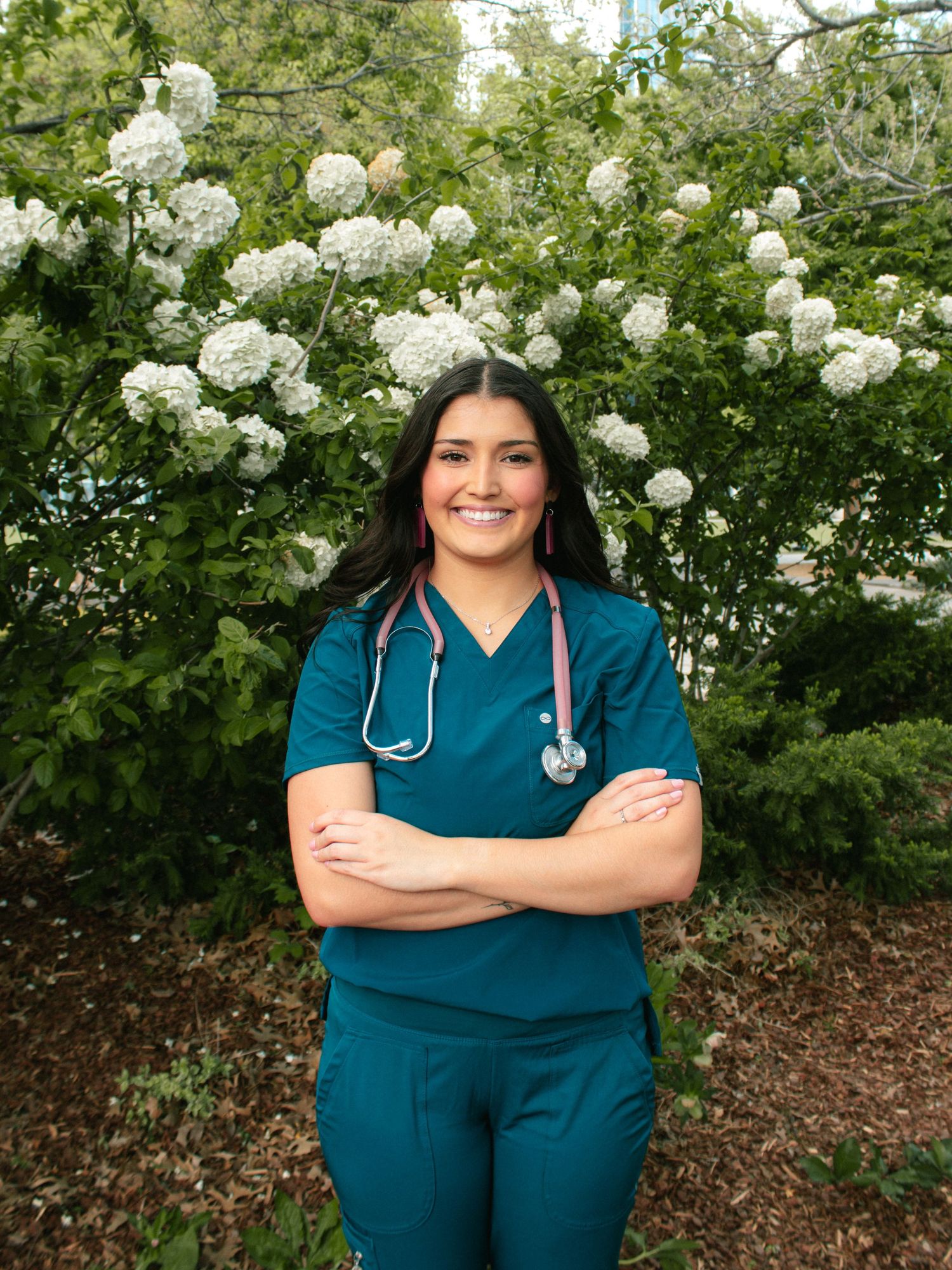 Nursing Student Poses for Senior Portraits Near Color Curve Blooms In Myriad Botanical Gardens