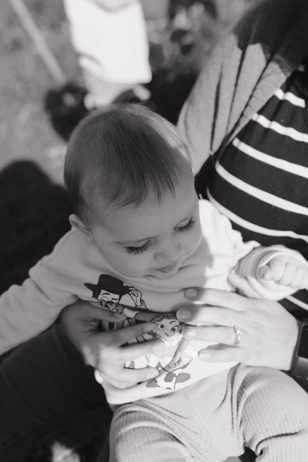 Black and white photo sequence showing a sleeping infant resting on a striped surface.