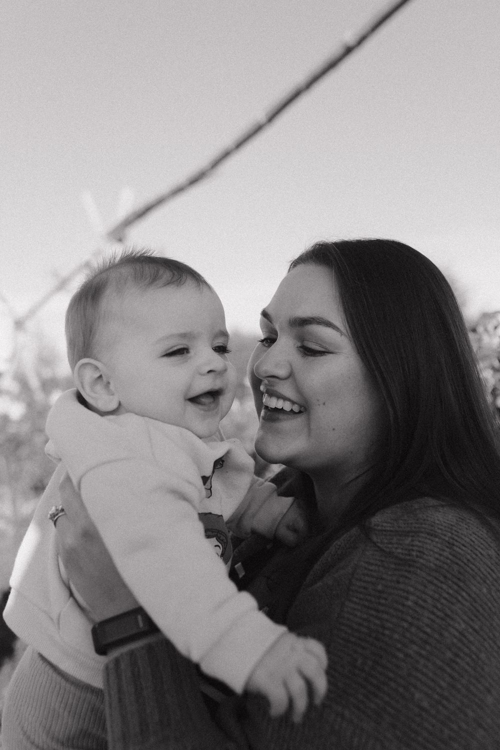 Black and white photo sequence capturing tender moments of affection and laughter.