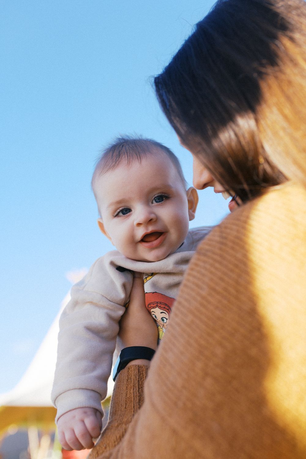 Series of candid moments showing an infant in light clothing against a bright background with joyful expressions.
