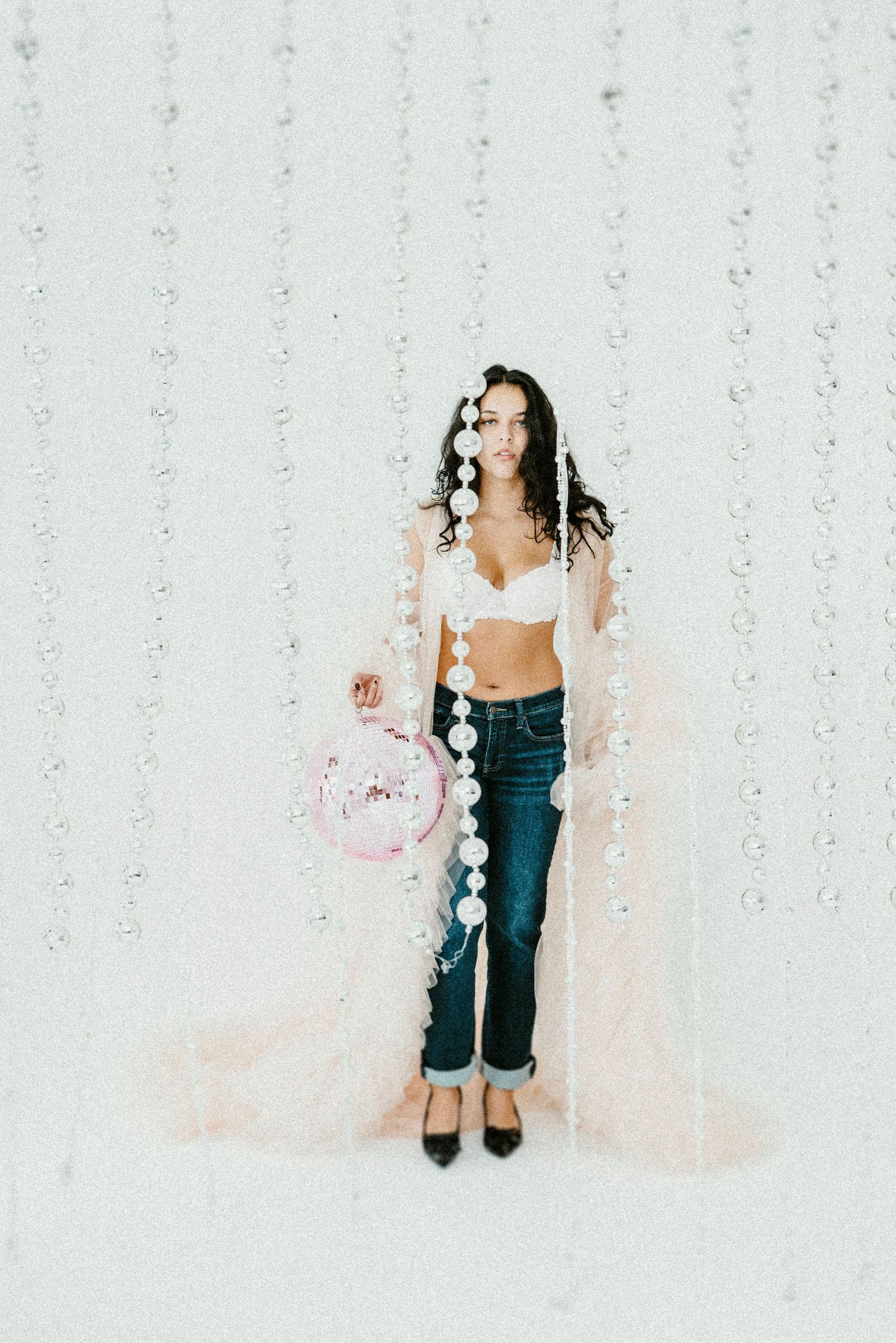 Three-part photo sequence showing someone playfully tossing pink confetti against a white sparkly backdrop.