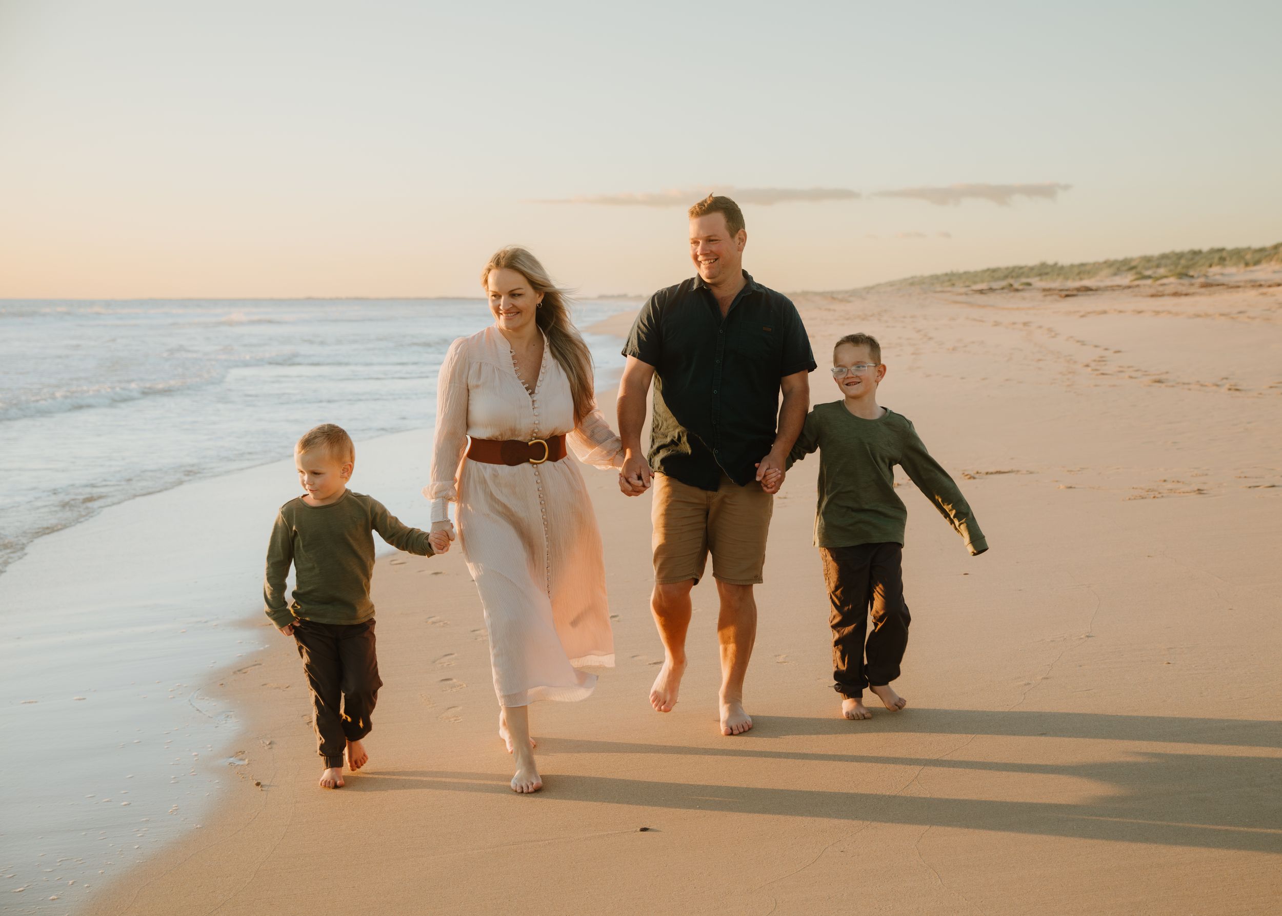 A family walking along the beach at the golden hour.
Victoriana Louise photography