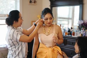A series of photos showing a couple helping each other get dressed and ready for a formal event.