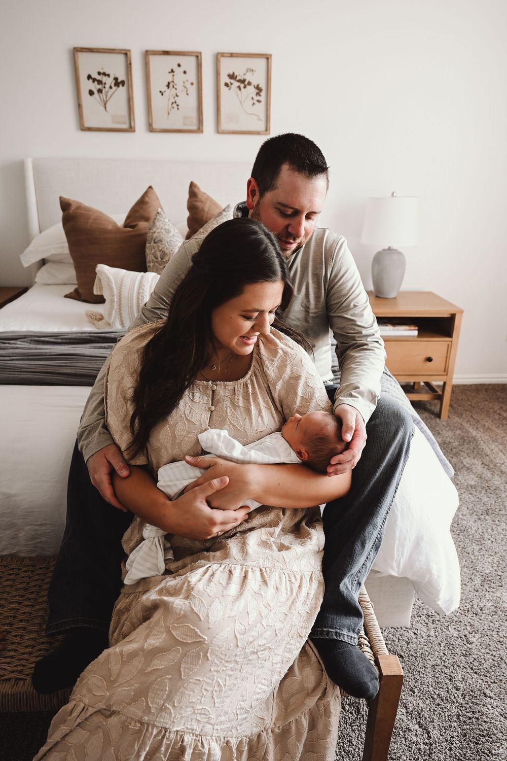 A family shares tender moments with an infant in a cozy home setting.