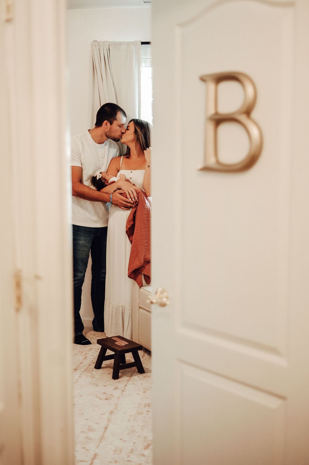 Romantic sequence showing a couple in a bright hallway near a doorway.