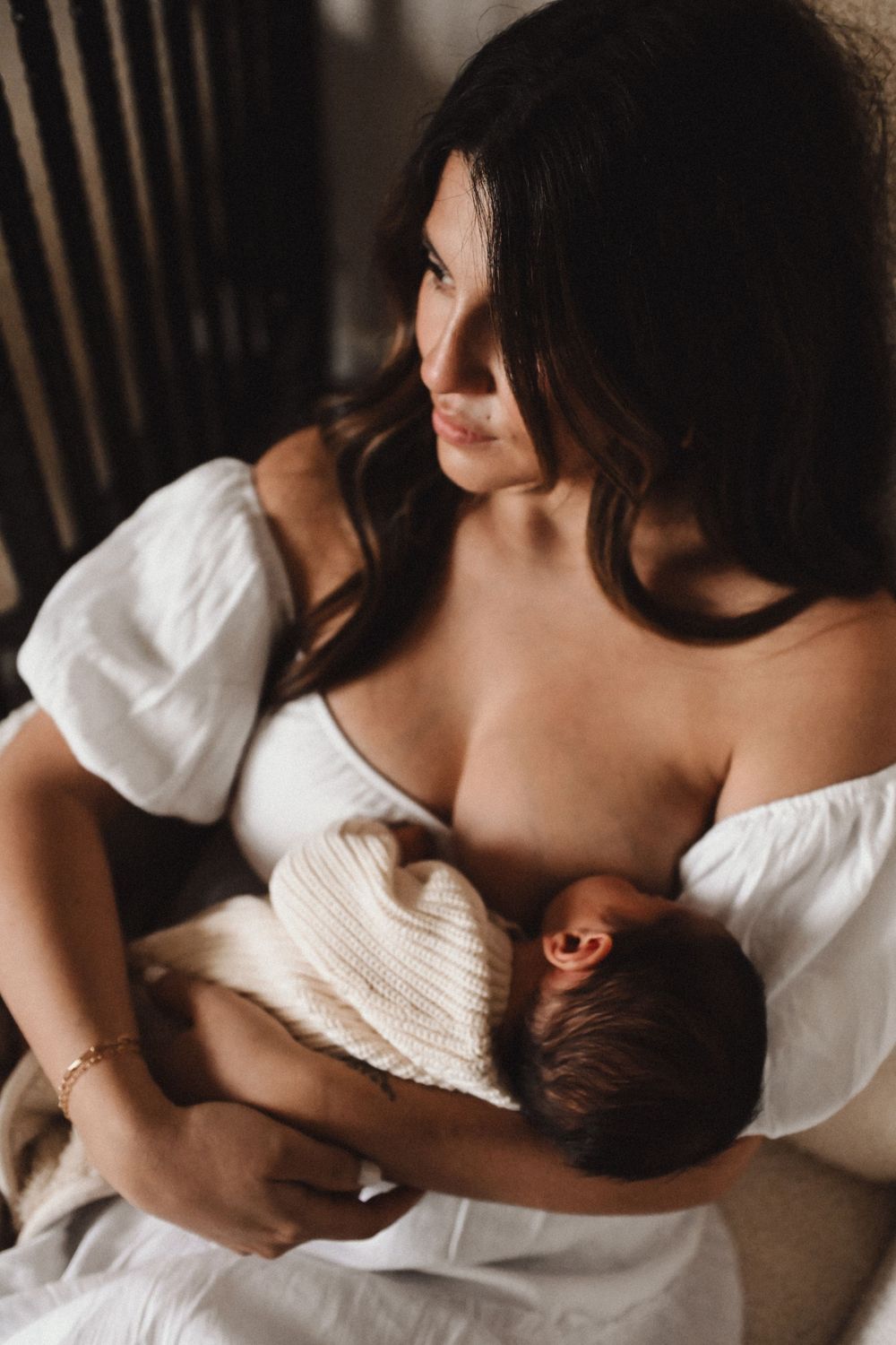 Intimate nursing moments captured in soft, natural light.