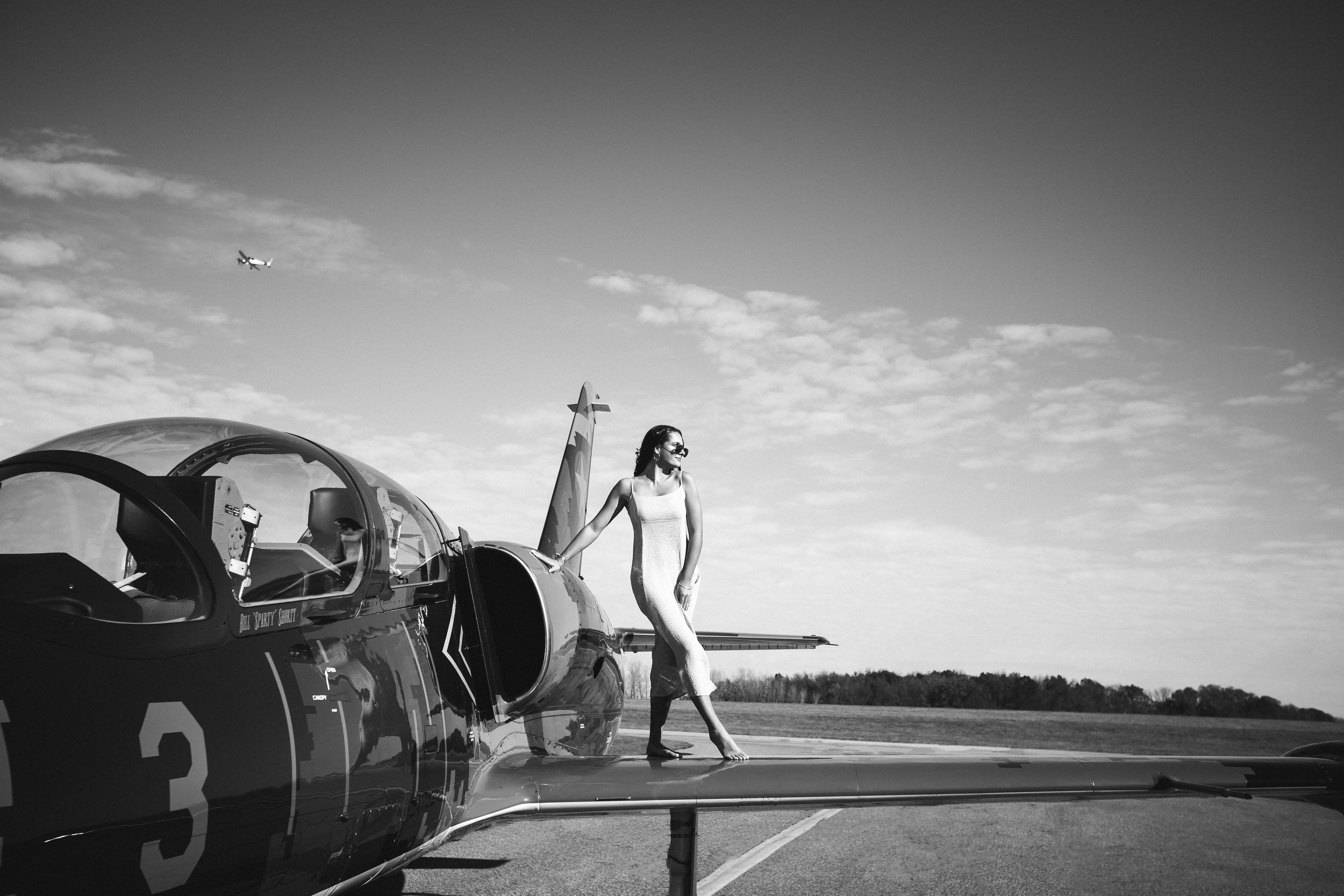 High school senior girl on jet plane; editorial portrait, fashion and aviation portrait session by Brighton, Michigan photographer in Howell