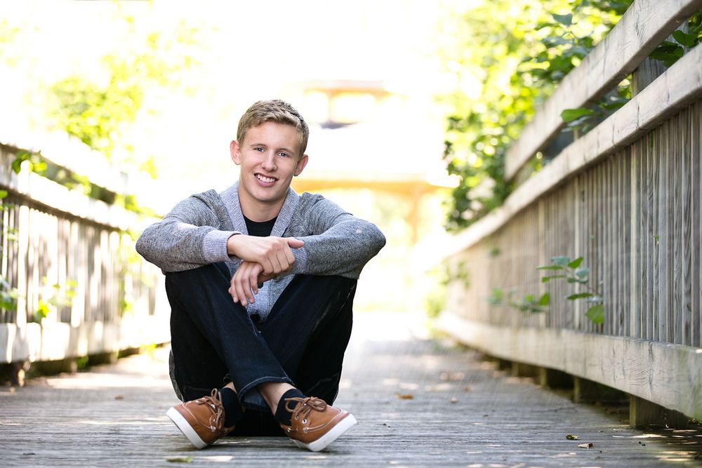 High school senior boy on bridge; senior portrait session in South Lyon, Michigan by Brighton, MI photographer