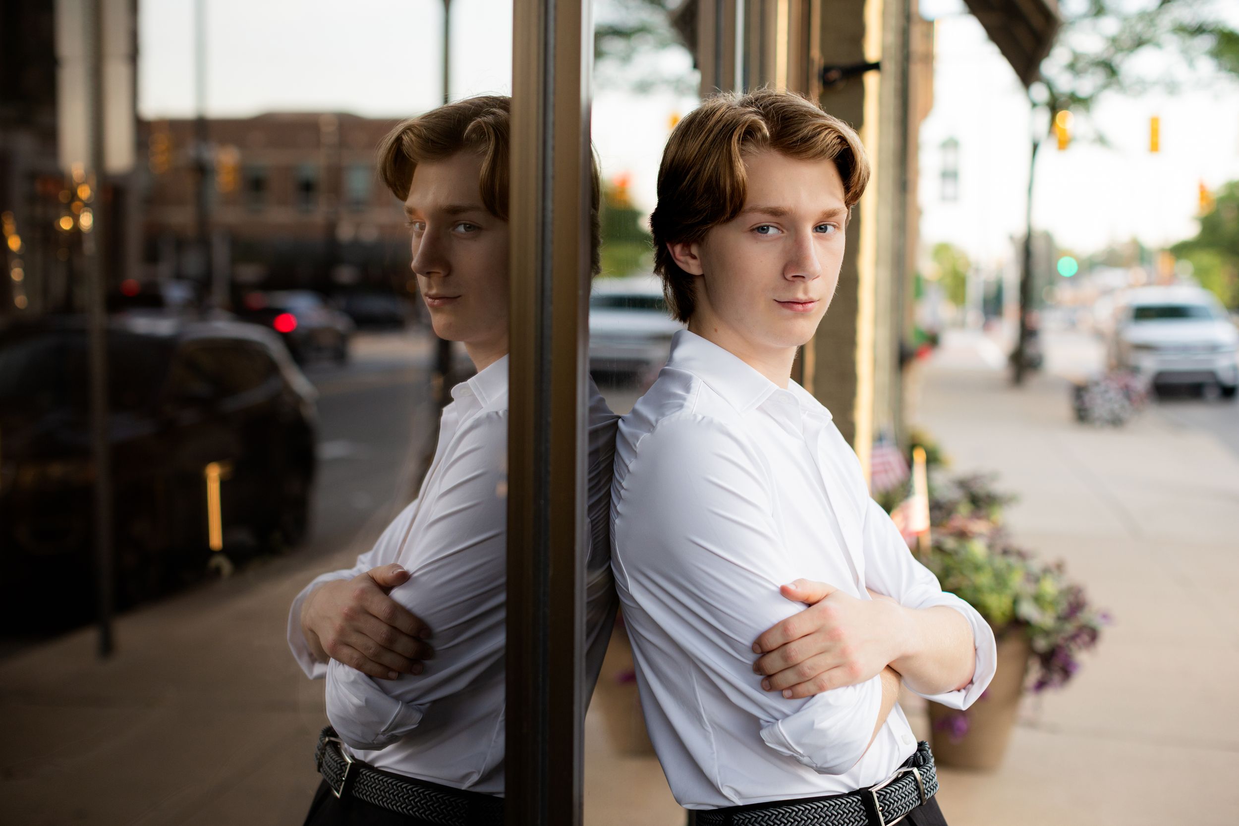 Urban senior portrait session of high school boy in downtown Howell, MI by Brighton, Michigan photographer