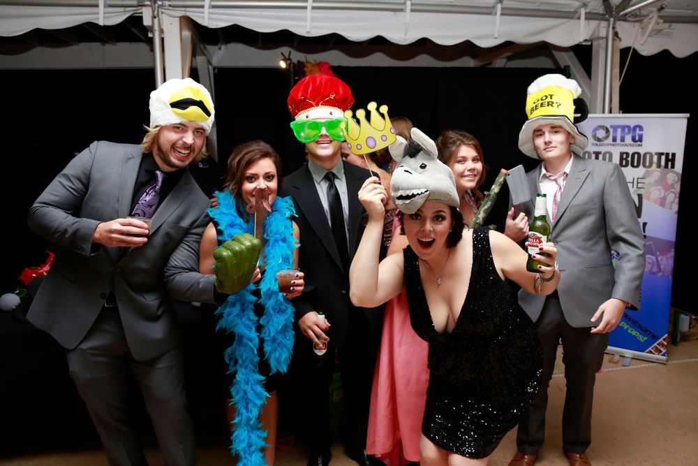 Party guests pose with colorful props and accessories in a photo booth strip with five connected frames.