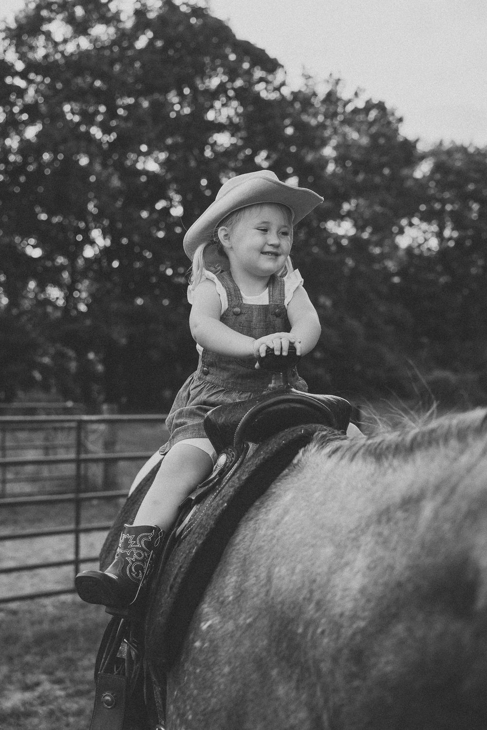 A sequence of black and white photos showing a child riding horseback in overalls and a hat.