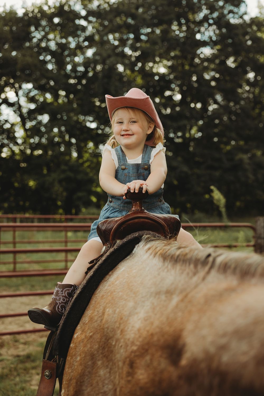 A series of photos showing a young rider in denim overalls sitting atop a light-colored horse in a fenced area.