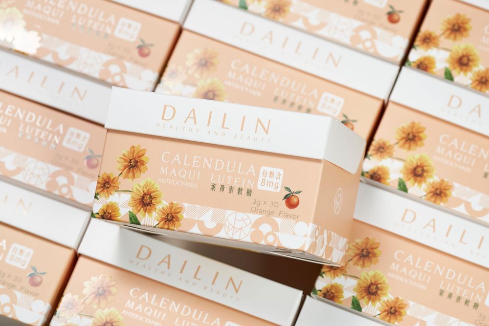 Stacks of Dailin branded boxes with sunflower designs arranged in neat rows on a white surface.