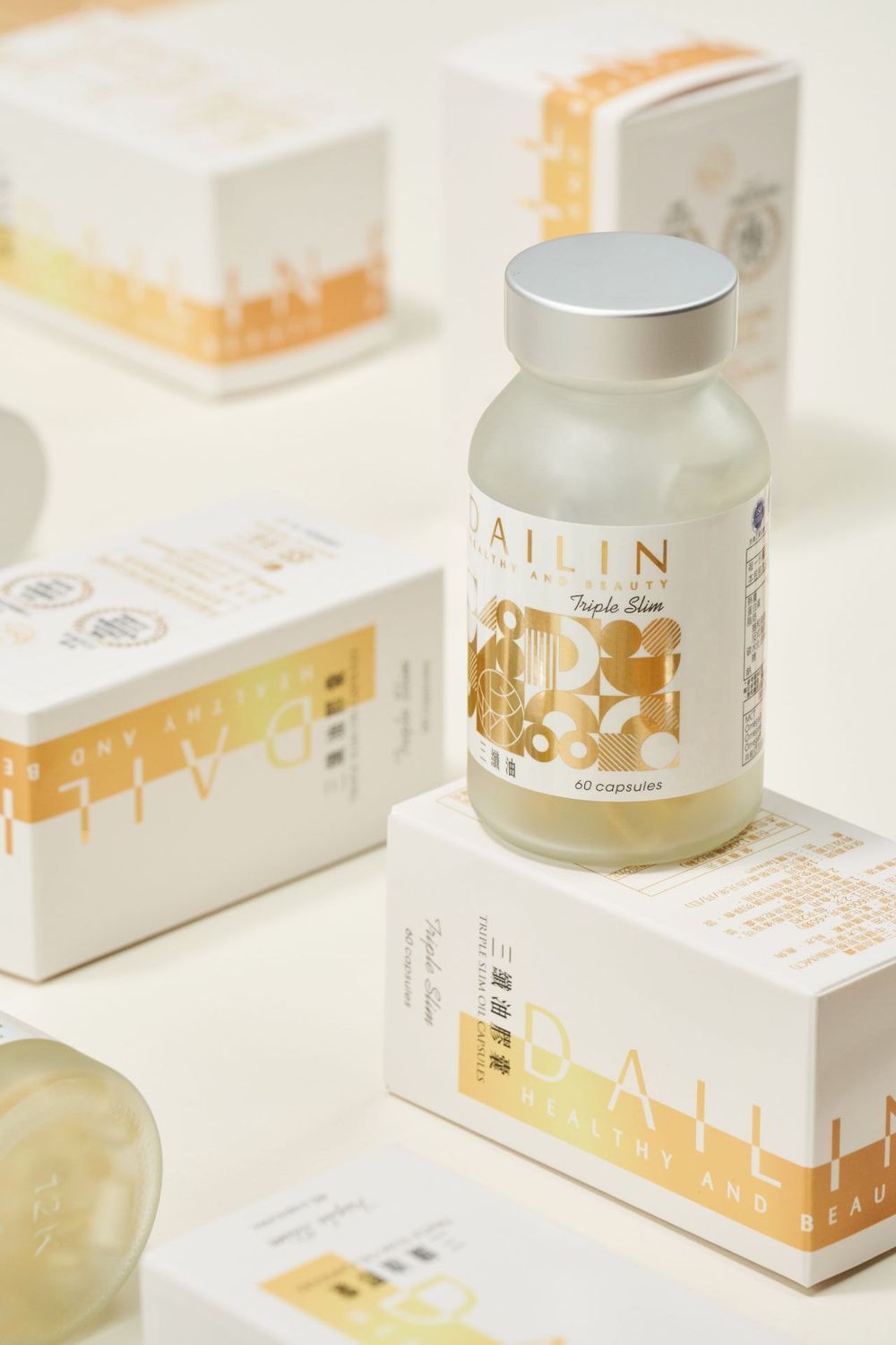 Luxury white and gold skincare product packaging with cream jars and boxes arranged on a bright white surface.
