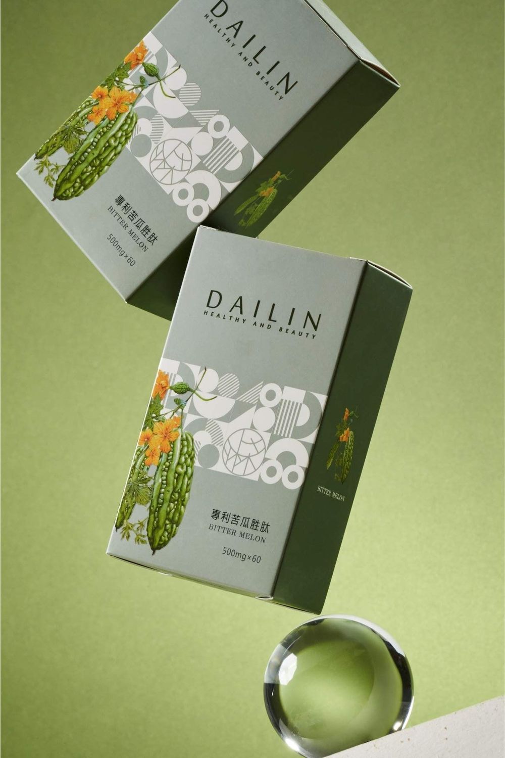 Two green Dallin skincare product boxes displayed with a clear glass sphere on a light green background.