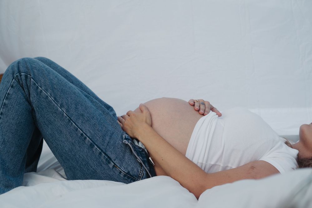 Maternity session outdoors with siblings, playful paint, colorful family photos, natural light, candid moments, lifestyle photography.