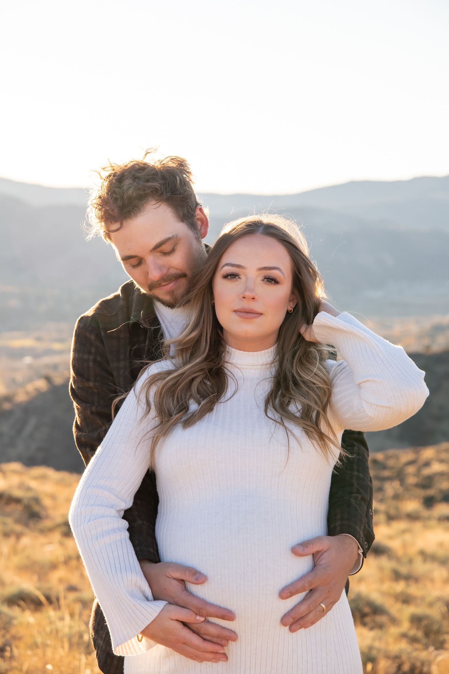 Serious and moody maternity session with a stylish couple in the mountains close to Vail Colorado.