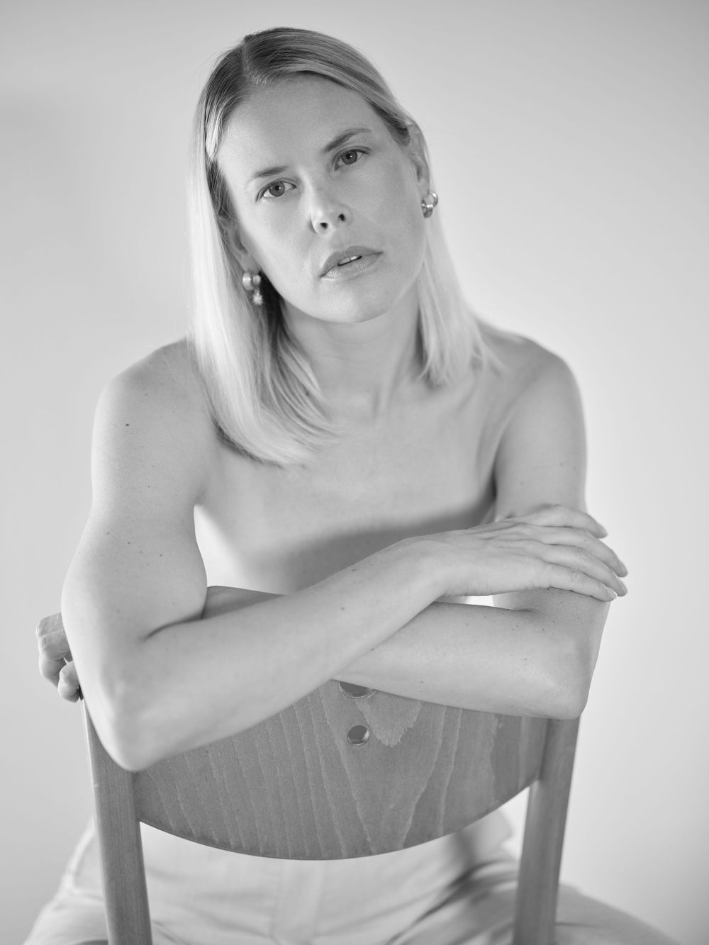 A series of black and white artistic portraits showing a person in various contemplative poses against a white background.