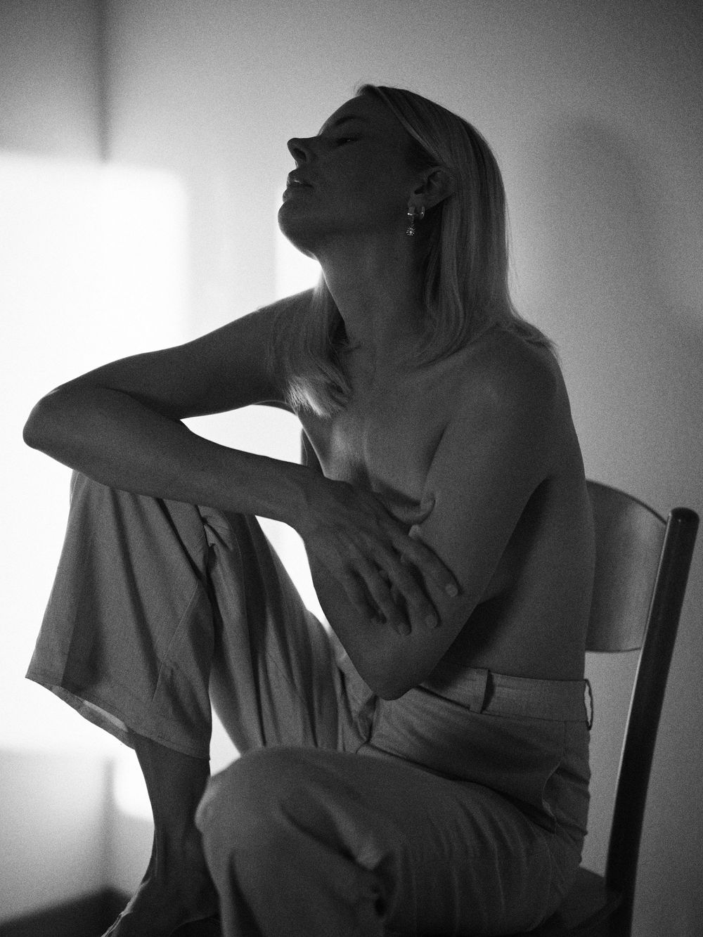 A dramatic black and white photo series showing silhouettes of two people in an intimate embrace against a bright window.
