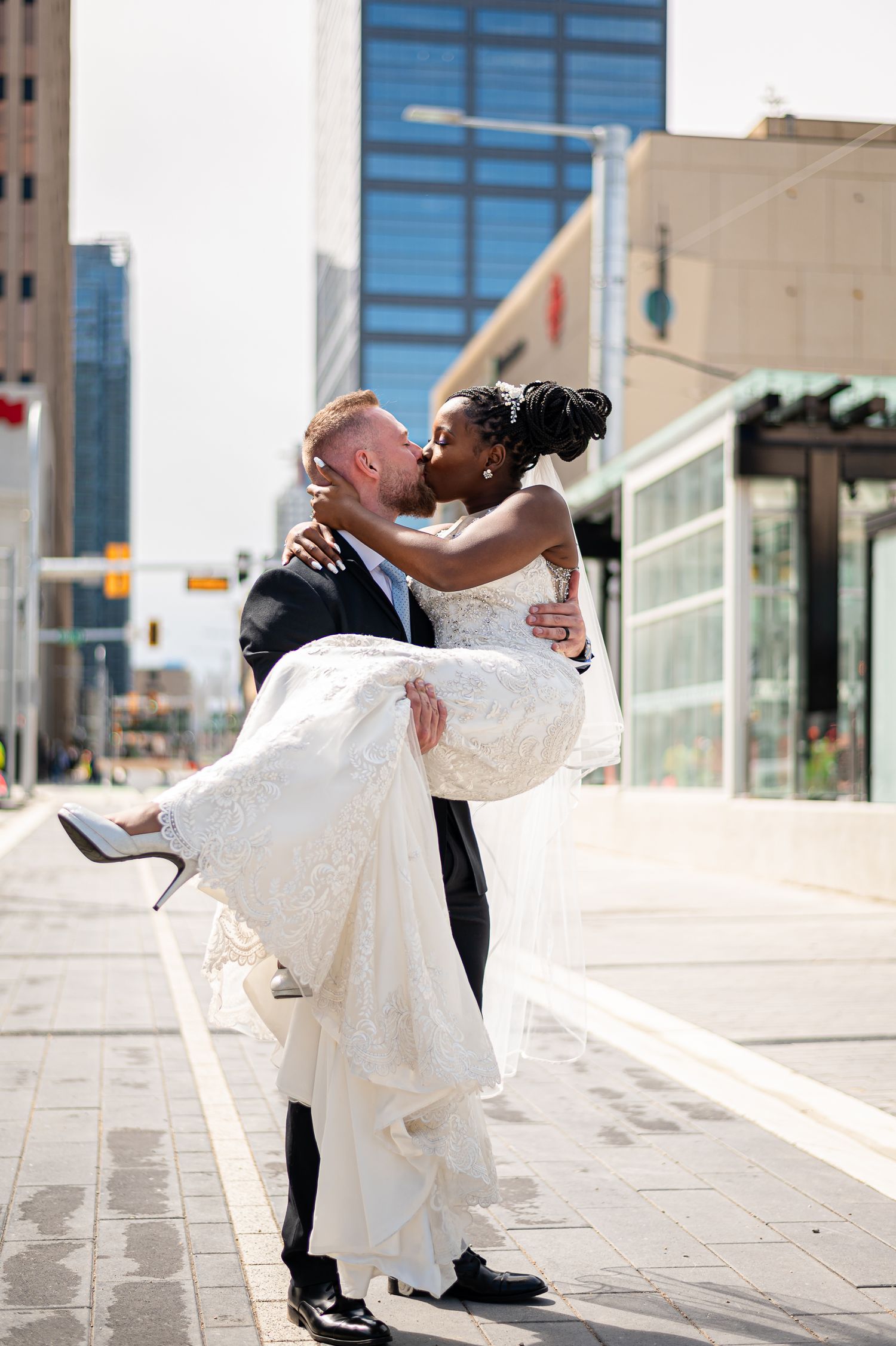 A sequence of romantic dance dips captured outdoors against a modern architectural backdrop.