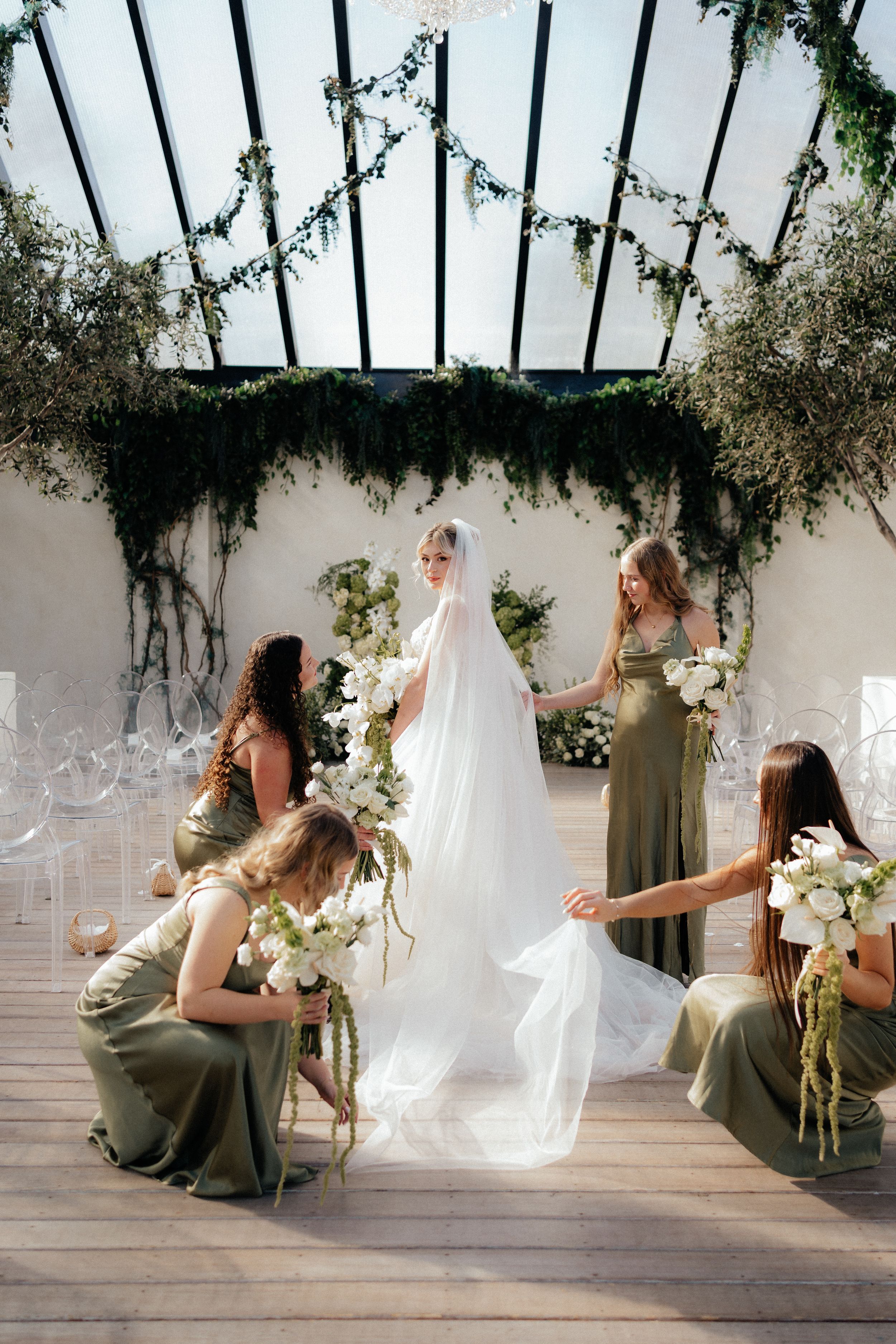 A series of artistic wedding photos showing flowing white veil movement against green foliage and bridesmaids in sage dresses.