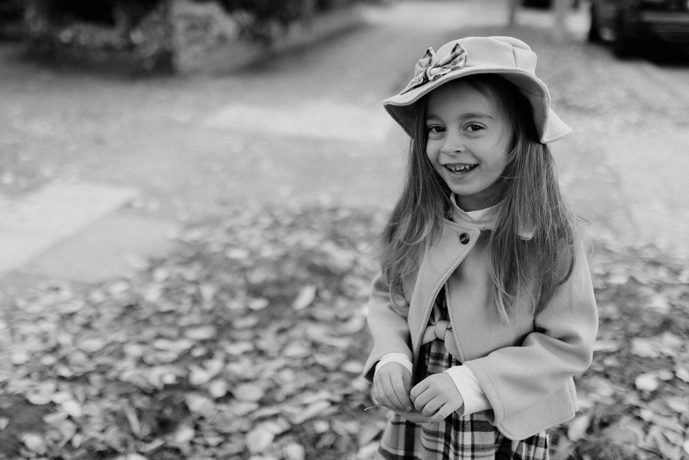 A collection of black and white photographs showing children playing outdoors in a casual, candid setting.