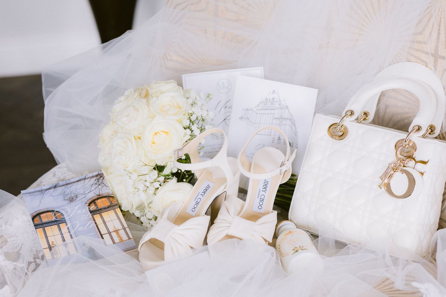 Elegant wedding decor featuring white hydrangeas, gold accents, and delicate place settings on a formal table.