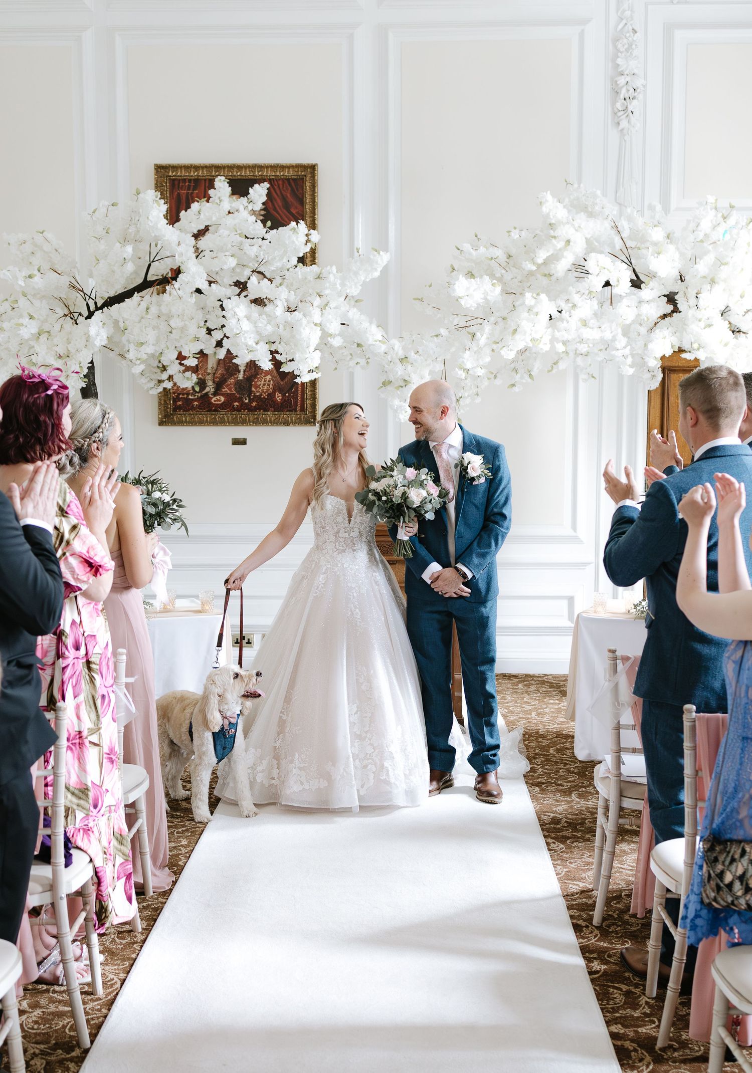 A tender black and white photo sequence captures a romantic first kiss moment at a wedding ceremony.