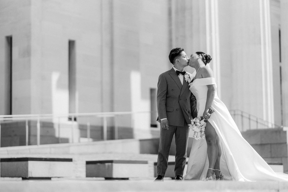 Black and white wedding photography against classic architectural columns.