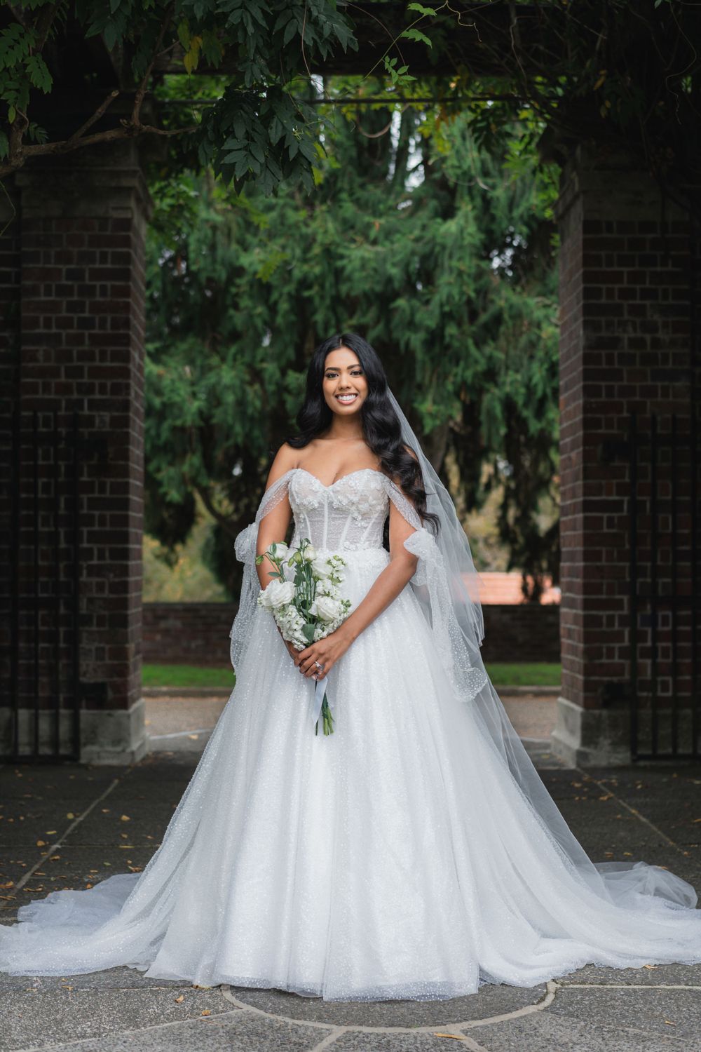 Full-length bridal portraits showcasing a stunning white ball gown and cathedral veil.