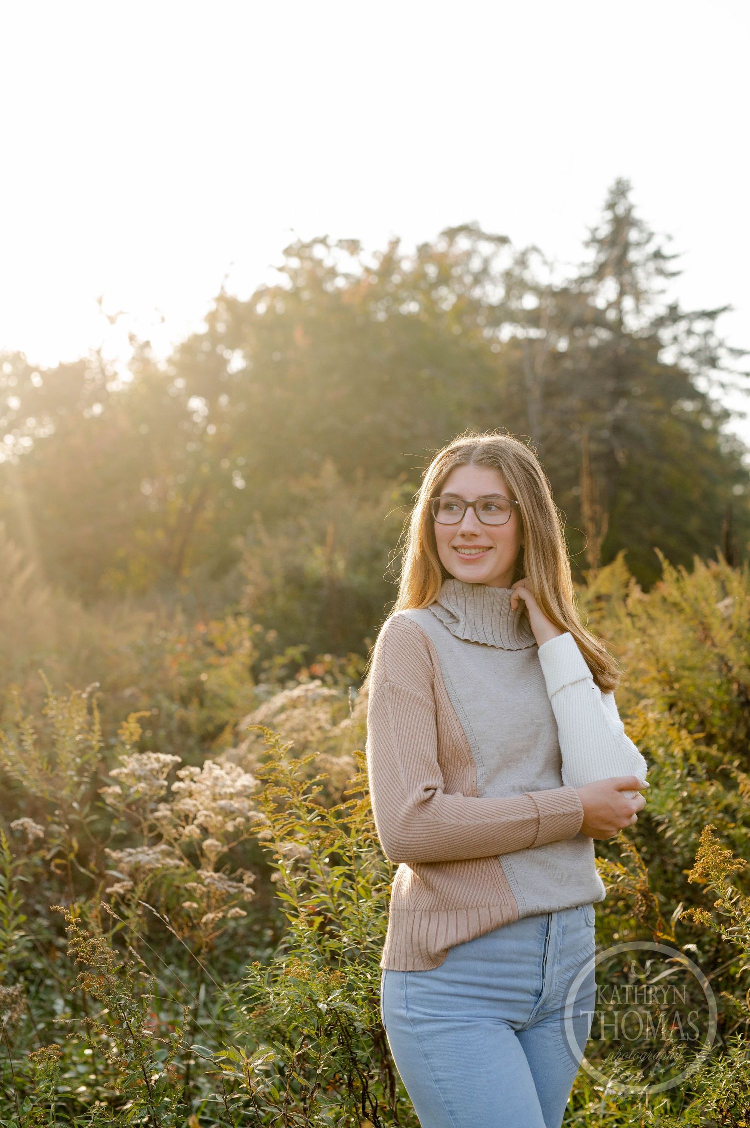 Warm sunset light creates a golden glow in this outdoor portrait among wild flowers.