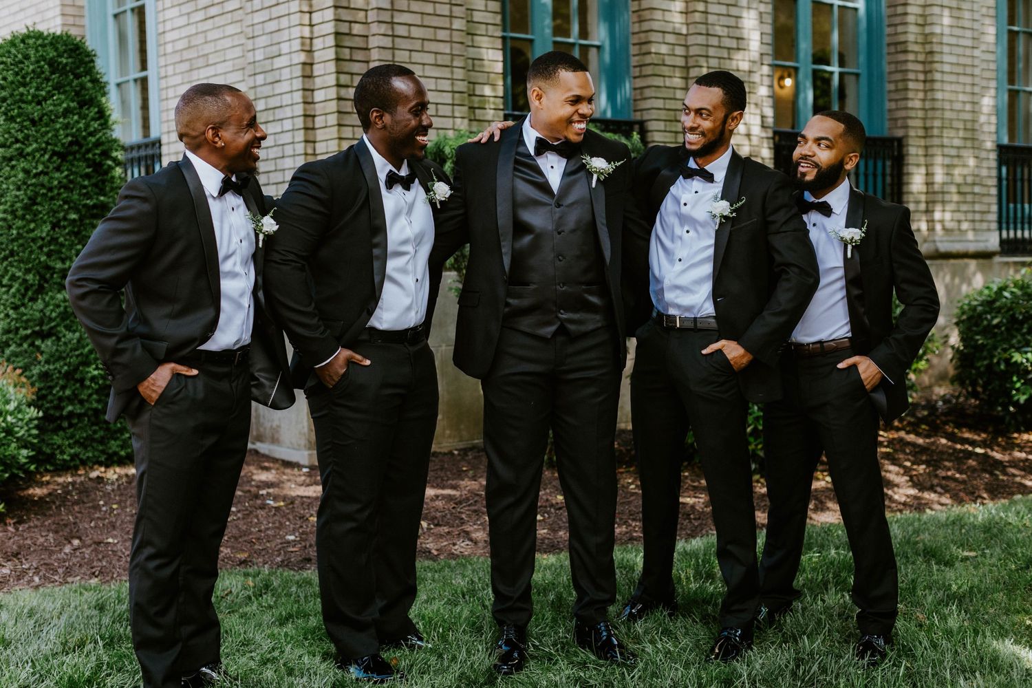 candid groomsmen group shot outside historic post office