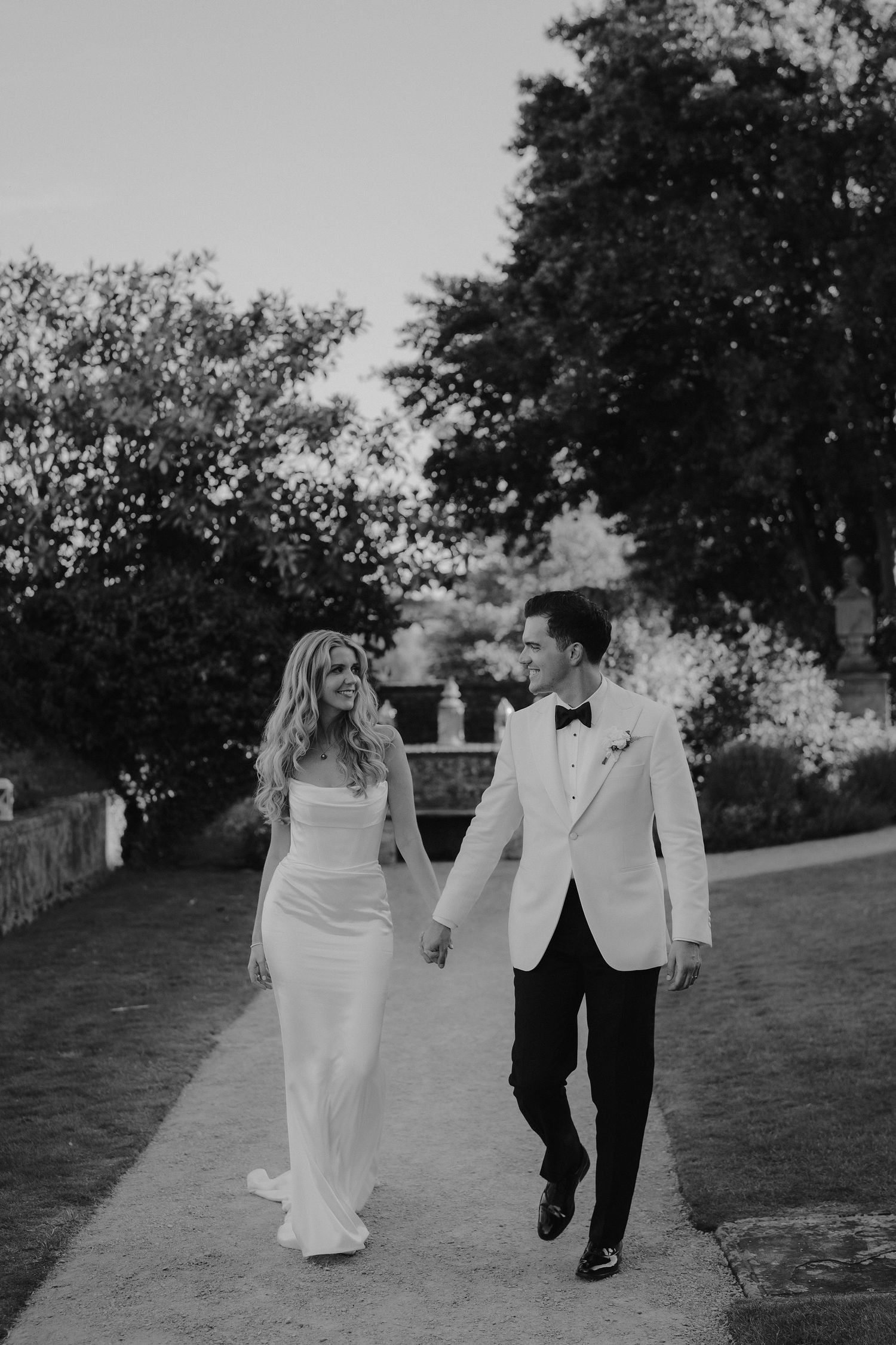 bride and groom walking and smiling at eachother at hamswell house wedding in bath