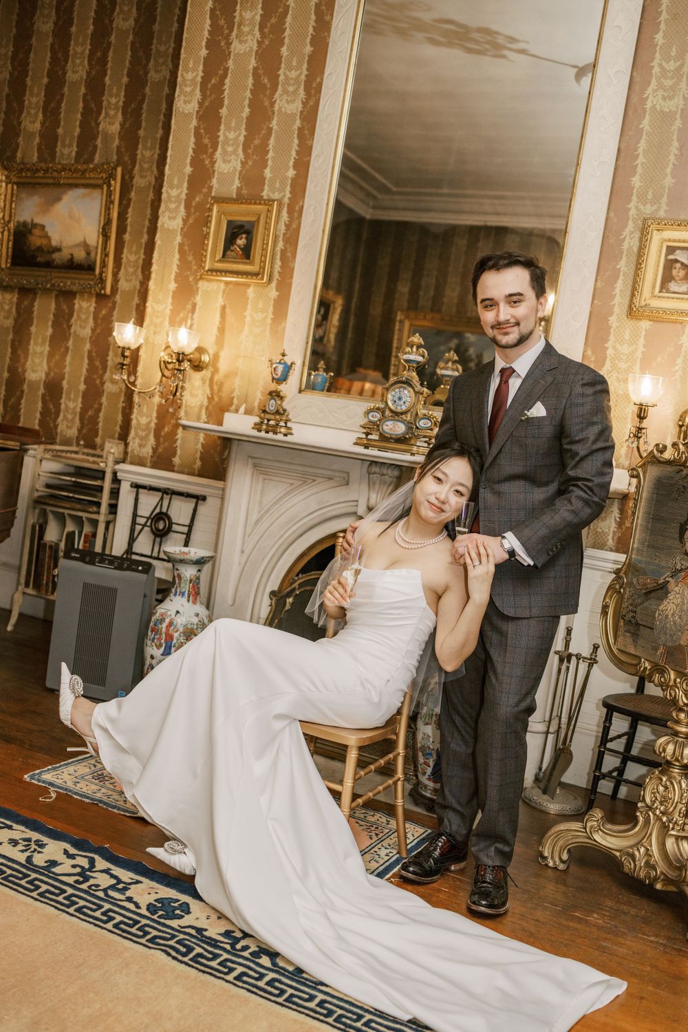 Playful wedding poses captured in ornate room with classical furniture and decor.