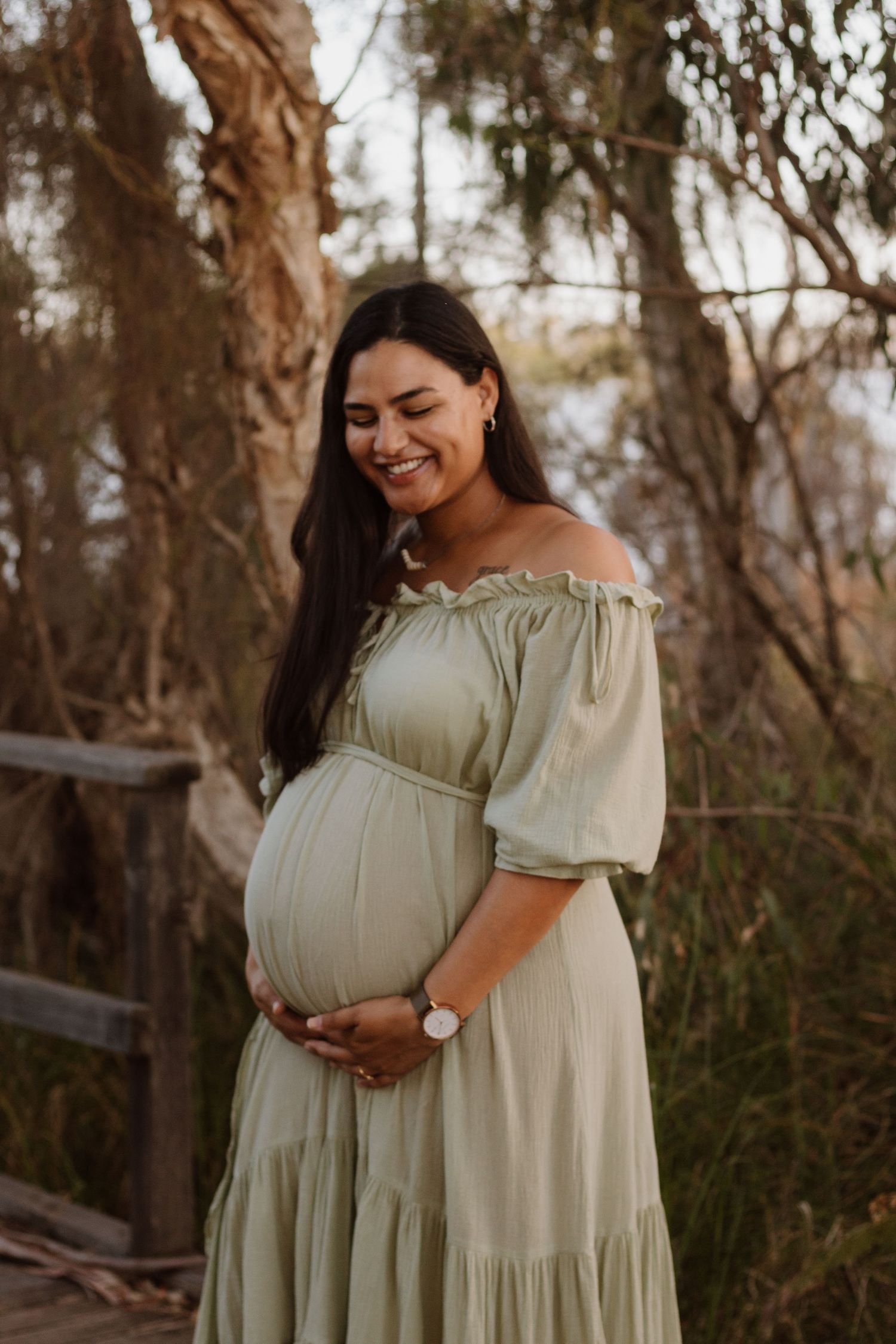 Maternity photoshoot outdoors at golden hour
