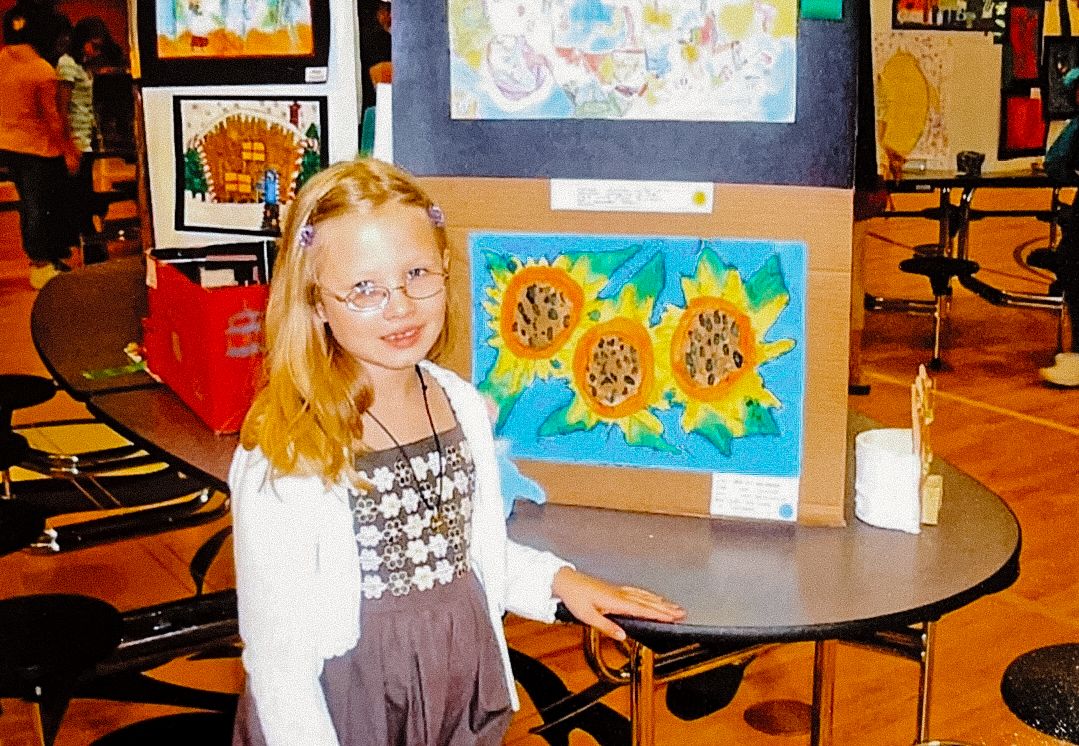 School classroom interior with educational posters and student work displayed.