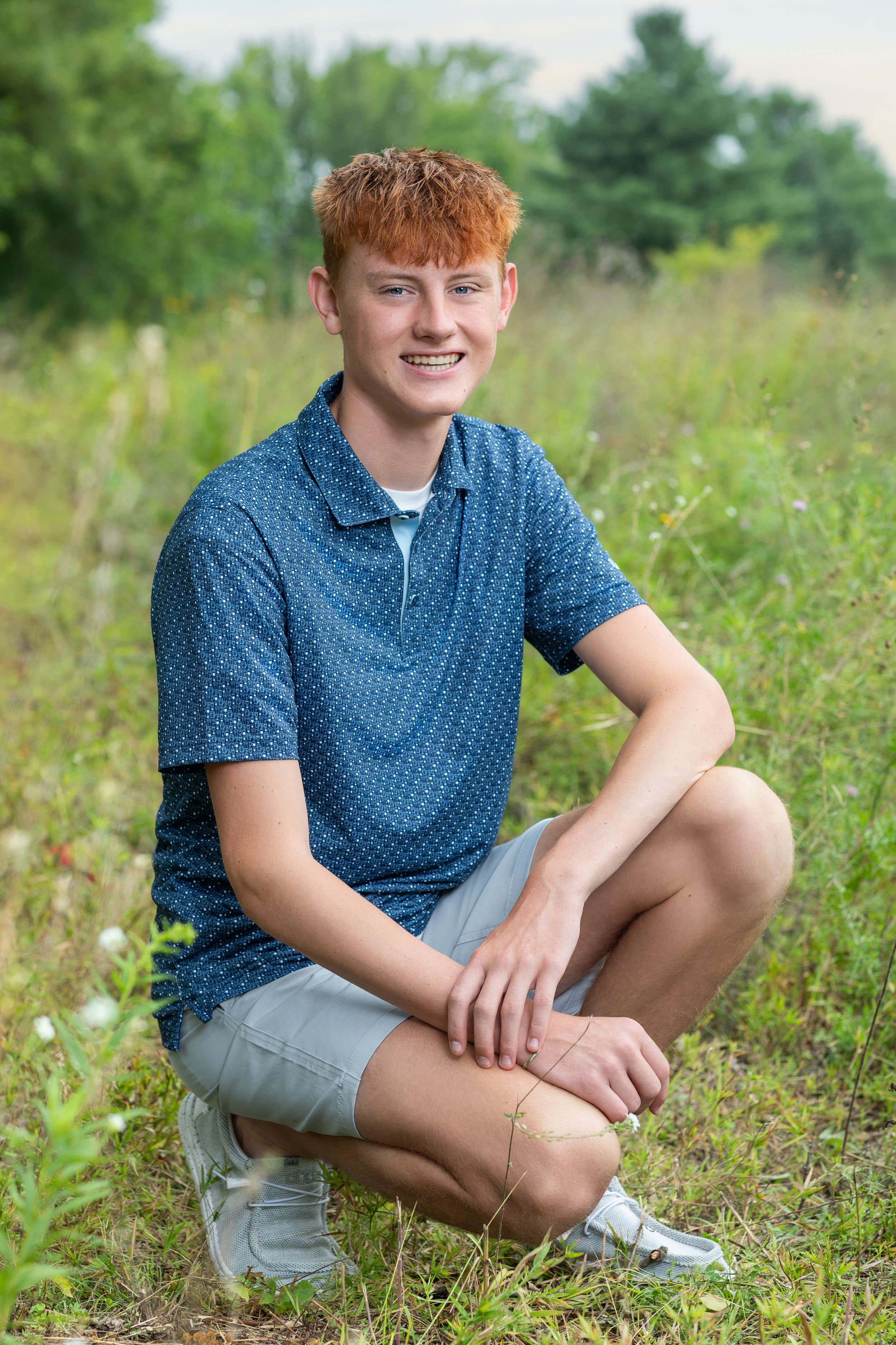 A series of outdoor portrait shots in a grassy field with wildflowers and green trees in the background.
