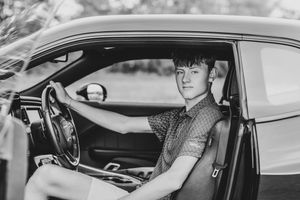 A series of black and white photos showing people sitting in car interiors with natural lighting.