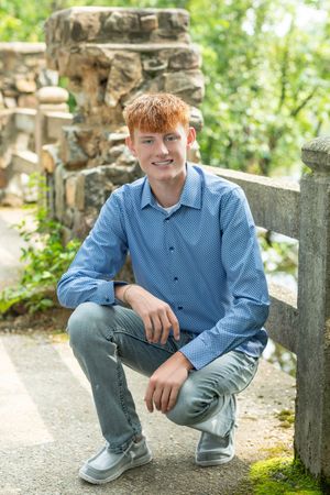 A series of outdoor portrait photos taken near stone walls and greenery on a sunny day.