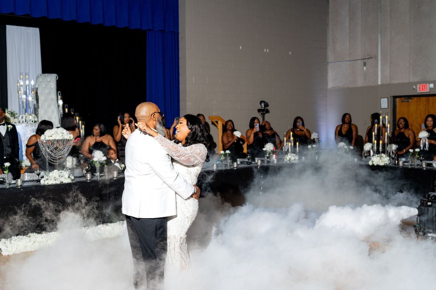 A chef performs a dramatic liquid nitrogen demonstration at an elegant banquet table setup with dramatic smoke effects.