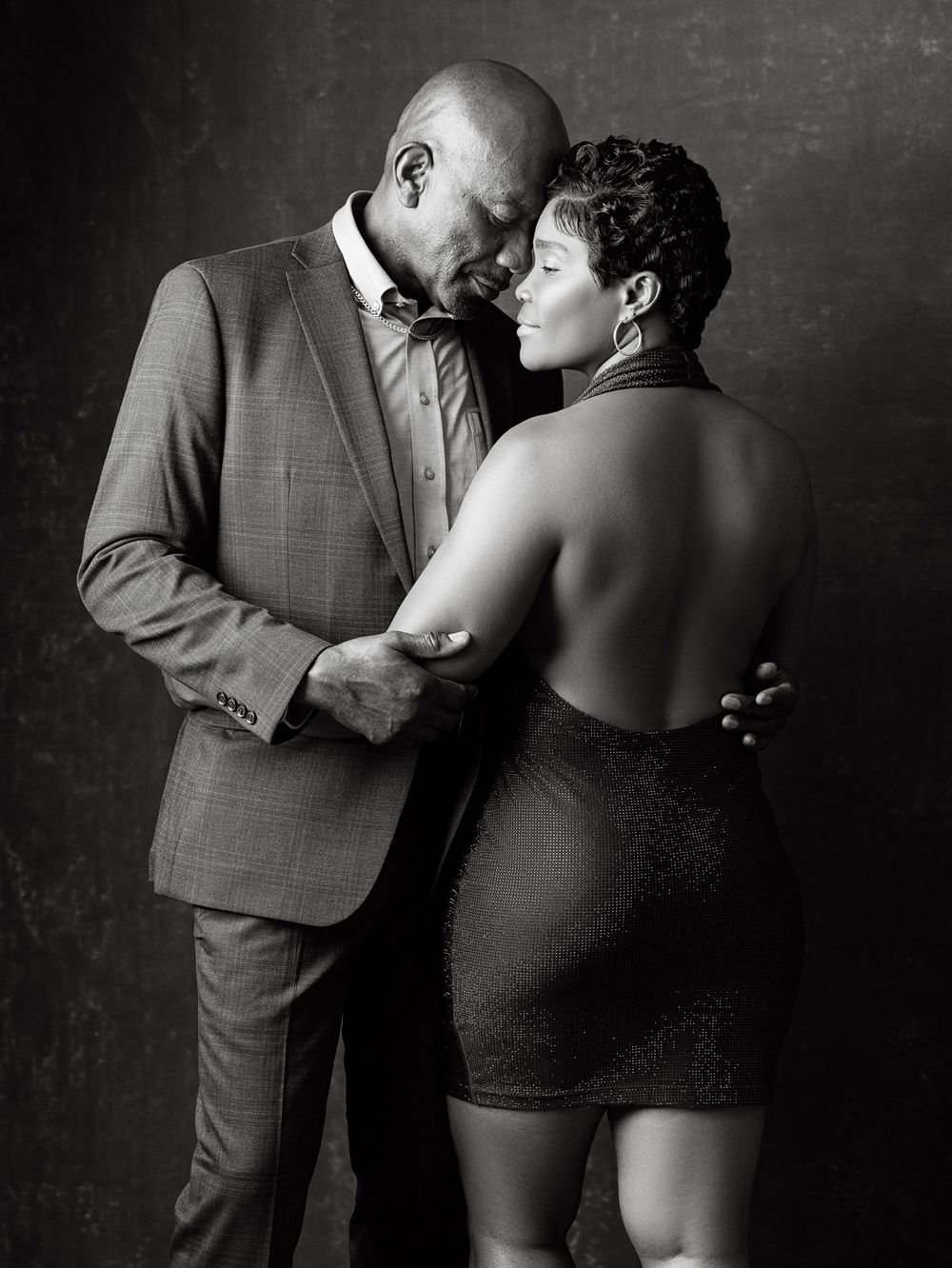 Romantic black and white photo series showing intimate dance poses between a couple in formal attire.