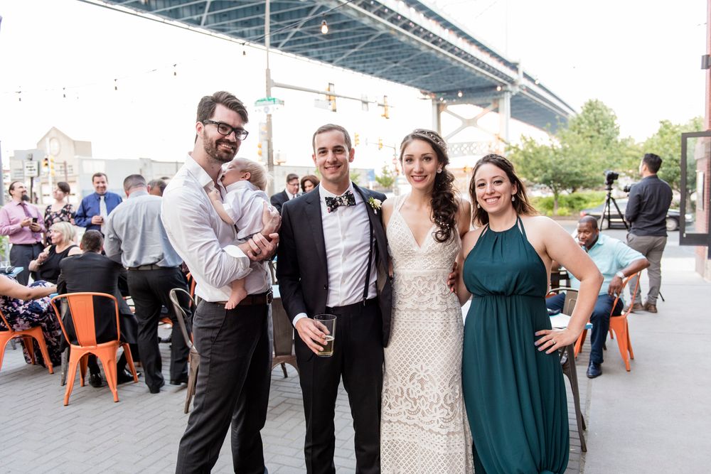 Wedding guests mingling outdoors at a casual reception gathering.