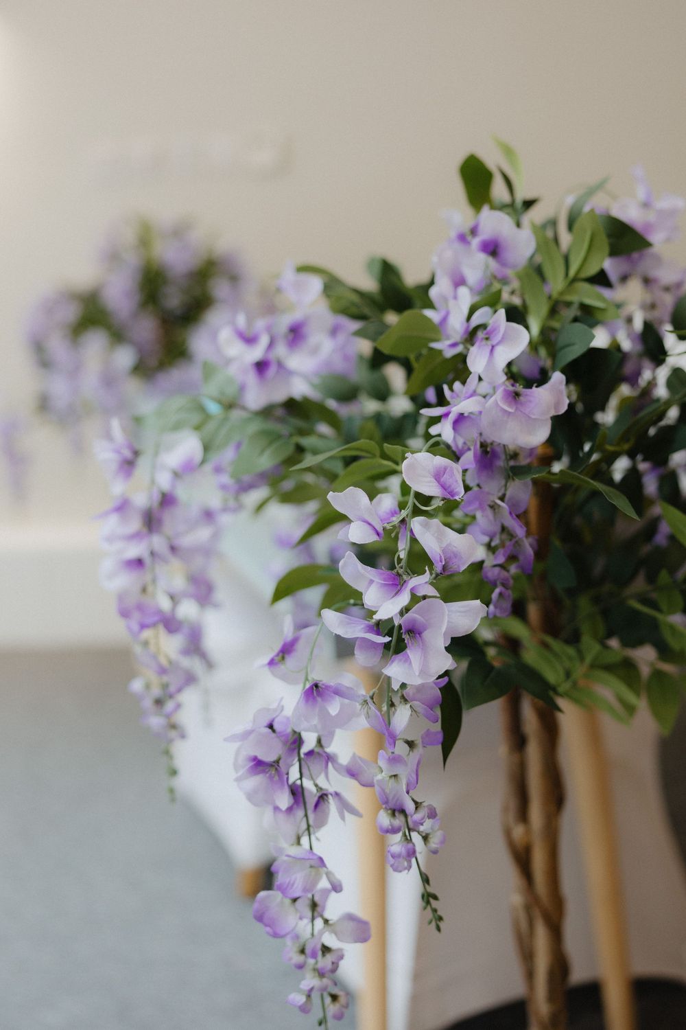 Delicate purple wisteria flowers arranged as wedding decorations.